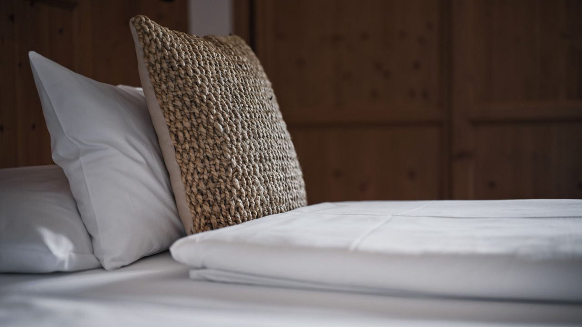 MOHR life resort Bildergalerie Nahaufnahme eines sauber gemachten Bettes mit weißen Laken und Kissen