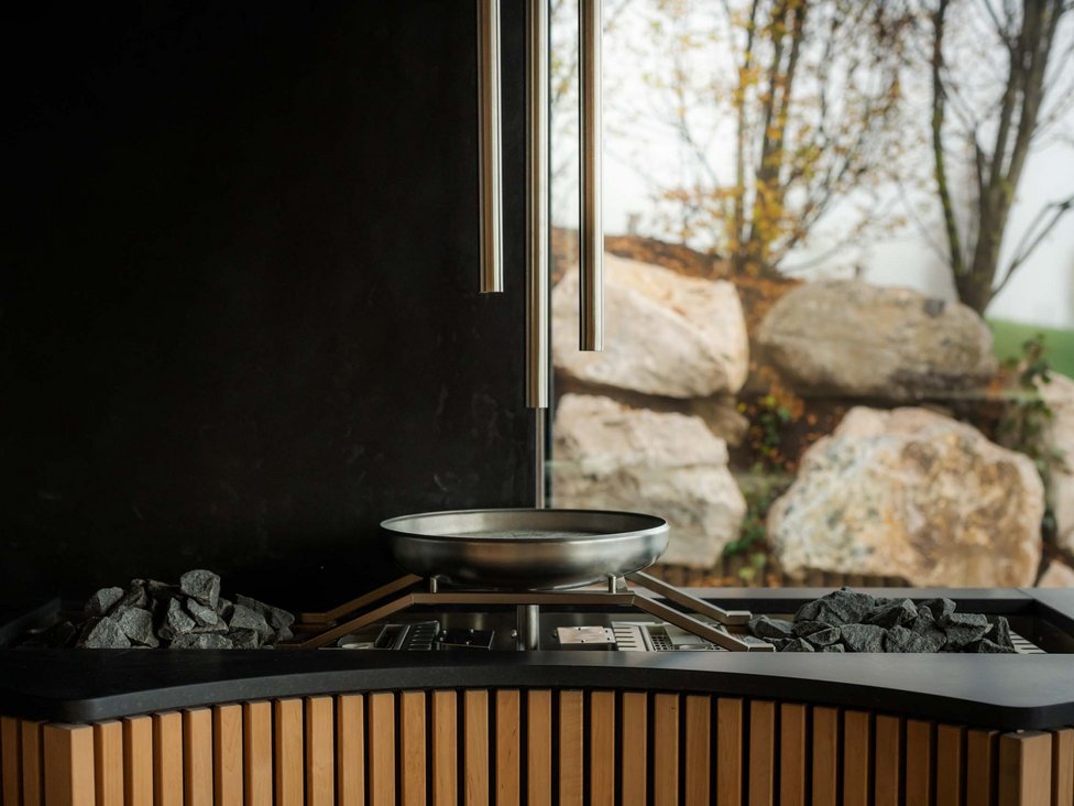Wellness und Luxus: Ihr Hotel in Tirol moderner holzofen mit sichtfenster und außenlandschaft im hintergrund