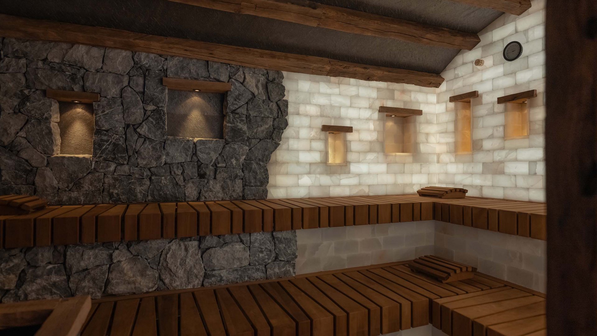 Großzügig und exklusiv: Ihr Wellnessurlaub in Tirol Innenraum einer Sauna mit Holzbänken und beleuchteten Steinwänden