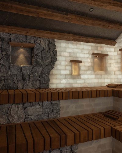 Ihr Golfhotel in Tirol – MOHR life resort Innenraum einer Sauna mit Holzbänken und beleuchteten Steinwänden